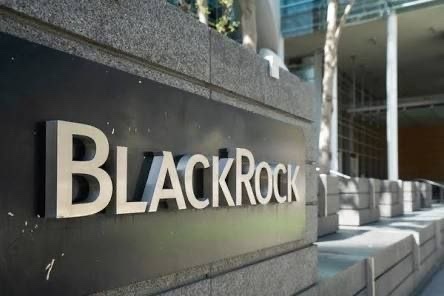 The image depicts a large, black and white sign for BlackRock Corporation located at an outdoor location such as a city plaza or office building. The text on the sign clearly states that BlackRock has added another $30.27 million worth of Bitcoin to its holdings. This indicates the company's involvement in Bitcoin transactions and further exploration into digital currency markets.