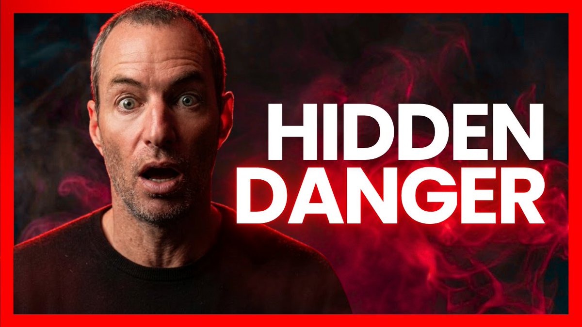 The image features a shocked-looking man with wide eyes alongside bold white text reading "HIDDEN DANGER," set against a dramatic red-bordered background with smoky red and black tones, visually emphasizing the warning tone of the post about the hidden risks behind altcoins overtaking Bitcoin in open interest and the dangers retail investors face from debt monetization-driven market traps.