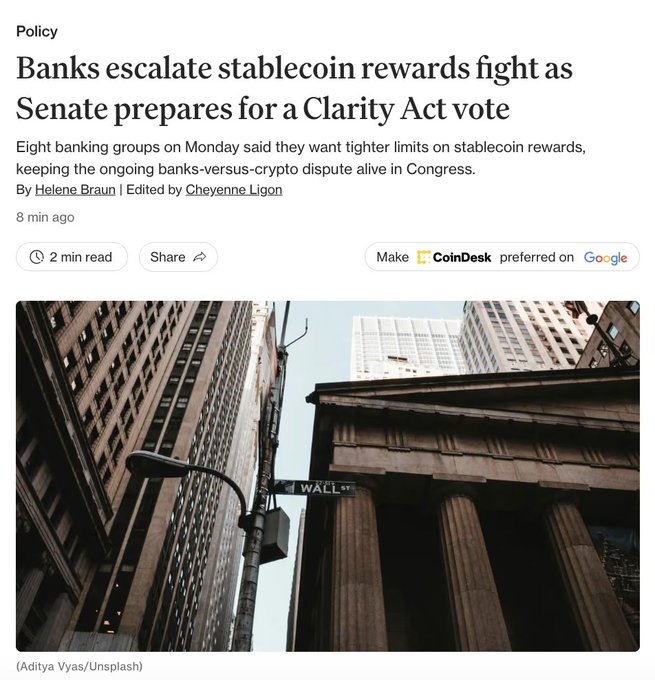A CoinDesk policy article headlined "Banks escalate stablecoin rewards fight as Senate prepares for a Clarity Act vote" is shown, featuring a photo of Wall Street's classical-columned building. The image visually reinforces the article's focus on the ongoing banks-versus-crypto dispute over stablecoin reward restrictions in Congress.
