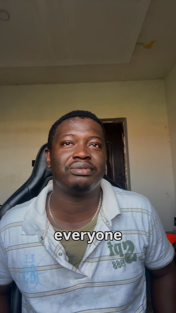 A seated man faces the camera indoors in a vertical video-style image, wearing a striped polo shirt and chain necklace; the subtitle reads “everyone.”