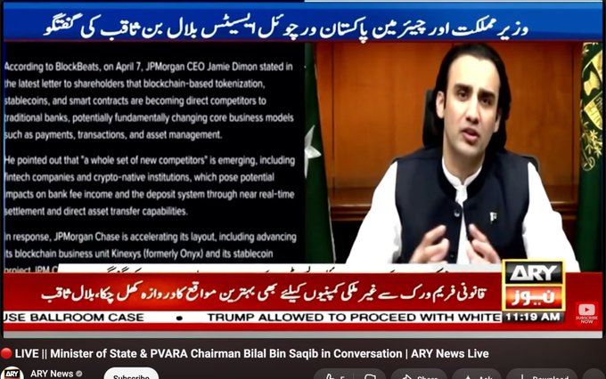 A screenshot from an ARY News broadcast featuring a discussion with the Minister of State & PVARA Chairman, with Urdu headlines and a news ticker about JPMorgan and blockchain competitors.