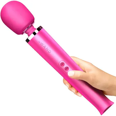This image shows a pink wand vibrator labeled "iWAND" being held by a hand. The caption compares cryptocurrencies to a whiskless hand mixer, highlighting their initial excitement but ultimate weariness, contrasting this with a more fulfilling experience.