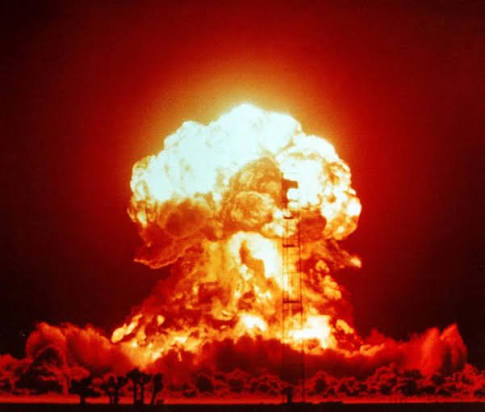 A massive fireball and mushroom cloud erupt from what appears to be a nuclear explosion test, with silhouetted figures and a tower visible against the fiery blast. The image of an atomic detonation visually reinforces the post's message about "CASHCAT" being reduced to zero.
