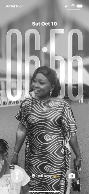 An iPhone lock screen on an 'Airtel Nig' network displays the time '06:56' and 'Sat Oct 10' over a black-and-white photo of a smiling woman in a patterned dress, with the music widget 'Deli Revv' at the bottom.