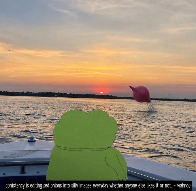 A sunset scene over water with a humorous photo edit showing a red onion digitally placed to appear as if it is leaping out of the water, with a green cartoon frog edited into the foreground watching it, captioned 'consistency is editing red onions into silly images everyday whether anyone else likes it or not. - wahndo'.