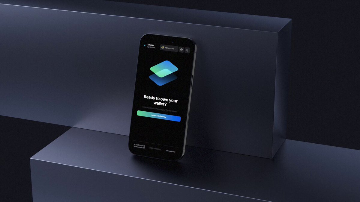 The image features a black smartphone with a blue square app icon displayed on its screen, which appears to be an Instagram app. The phone is placed on top of a gray block or shelf against a dark background. There are no texts or other objects in the image, and the focus is solely on the smartphone and its surroundings.