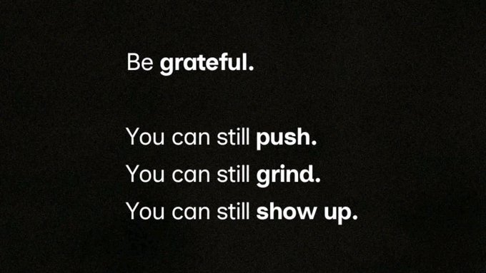 A black motivational graphic displays white text reading 'Be grateful. You can still push. You can still grind. You can still show up.'