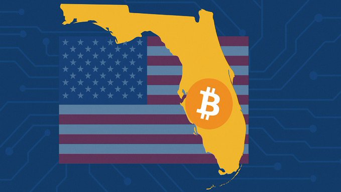 A graphic illustration showing the state of Florida in yellow overlaid on an American flag, with an orange circle containing the white Bitcoin logo positioned over the southeastern part of the state, all set against a blue circuit board background.