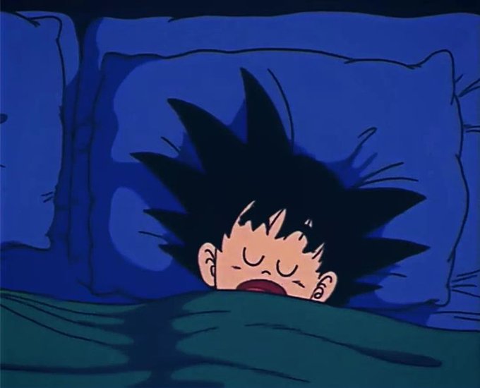 A young Goku from Dragon Ball sleeps peacefully under a blue blanket, his spiky hair fanned out on the pillow, embodying the post's morning message to "wake up with goals" as fellow Saiyans greet the crypto market with Bitcoin near $61,330 and Ethereum at $1,702 amid fear in the markets.