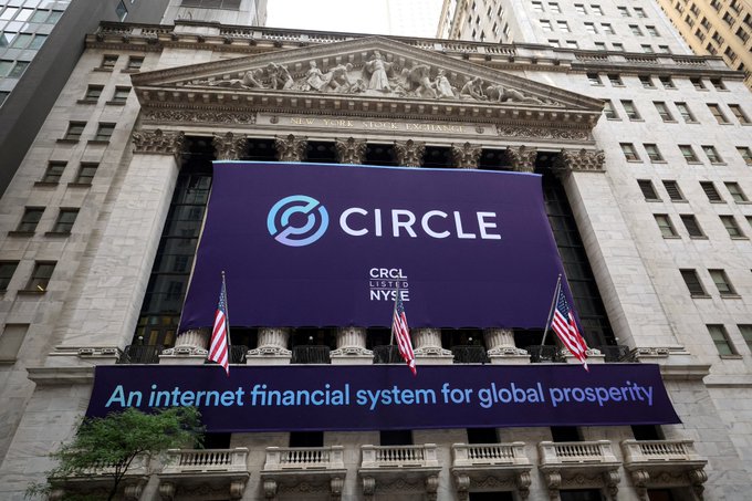 The New York Stock Exchange (NYSE) façade is draped with a large banner featuring Circle's logo, the ticker "CRCL" listed on the NYSE, and the tagline "An internet financial system for global prosperity," commemorating Circle's public listing following its acquisition of IBM's blockchain patent portfolio.