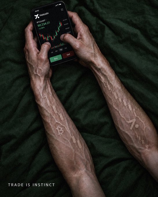 An advertisement image showing hands holding a smartphone displaying the Hotcoin BTC/USDT trading chart, with Bitcoin candle patterns tattooed on the forearms and the tagline "TRADE IS INSTINCT."
