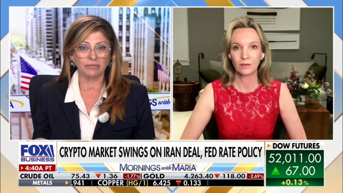The image shows a news segment featuring two women sitting behind a desk, discussing the impact of cryptocurrency market swings on Iran's economy. One woman wears glasses and appears to be wearing a suit, while the other woman has blonde hair and is dressed more casually in a red dress. The background includes text about Bitcoin and its influence on financial markets.