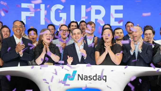 The image captures a jubilant moment of the Figure team and executives celebrating at the Nasdaq stock exchange podium, with the "FIGURE" logo prominently displayed in the background and confetti raining down around them. This visual commemorates their 1-year anniversary of being Nasdaq-listed under the ticker $FIGR, highlighting the company's milestone at the intersection of blockchain and AI in capital markets.