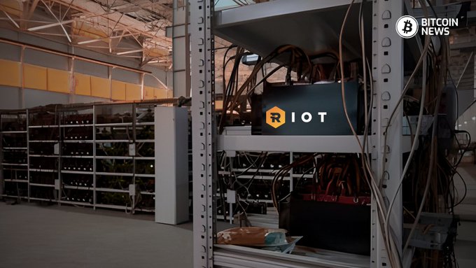 A Bitcoin mining facility with RIOT branded equipment, labeled with 'BITCOIN NEWS' in the top right corner.