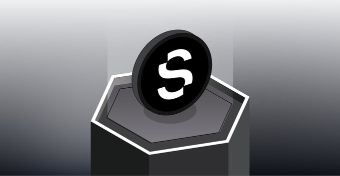 A 3D-rendered black coin featuring a stylized 'S' logo sitting on a dark pedestal against a gray background.