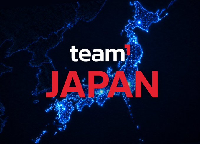 A dark map of Japan outlined in glowing blue dotted lights serves as the backdrop for the bold text "team¹ JAPAN" with the "1" in red. The illuminated map visually echoes the post's theme of institution adoption lighting the way for developers and builders across the country.