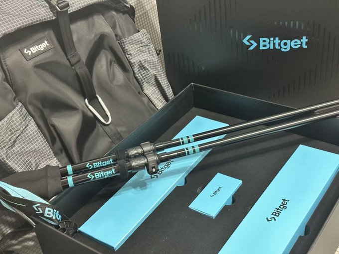 A promotional image showing a black backpack, two telescoping poles, and light blue packaging inside a box, all branded with the 'Bitget' logo.