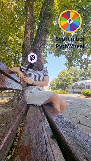 A woman sits on a wooden park bench beneath a large tree, with a colorful 'September PythWheel' graphic and Pinterest logo overlaid on the image.