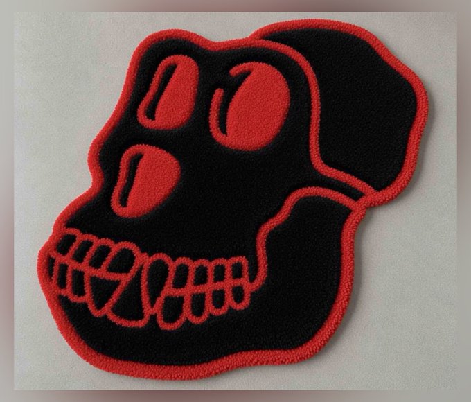 An embroidered patch featuring a stylized ape skull design in black with a red border. The post discusses letting the community vote on whether the final version should have a red or black border, with this patch showcasing the red border option as potential official Apefest merchandise.