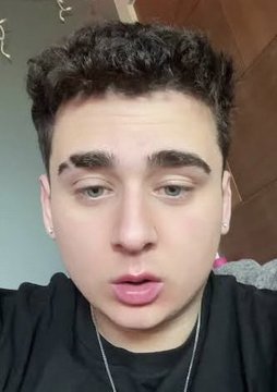 A close-up selfie of a young man with curly hair looking into the camera with a neutral expression, accompanying a post discussing community backlash and accusations of scamming related to $HYPE cryptocurrency discussions and trading collaborations.