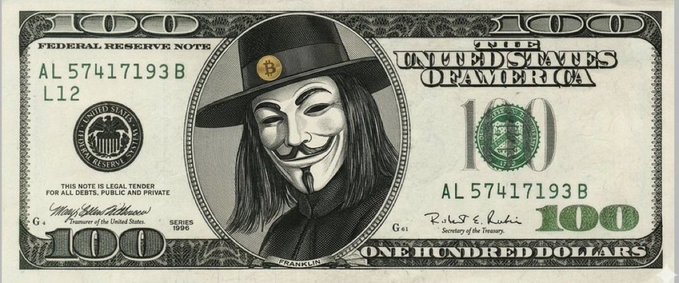 A modified $100 Federal Reserve Note featuring the Guy Fawkes "Anonymous" mask in place of Benjamin Franklin, with the phrase "HODL MY BEER" replacing "The United States of America." The image ties into the cryptocurrency giveaway post, using the Anonymous hacker symbol to lend an air of mystery and hype to the $100 prize drawing.