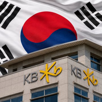 The image shows the South Korean flag above a building displaying the "KB" logo, representing KB Financial Group and its subsidiary Kookmin Bank, South Korea's largest bank at $400B, which is set to integrate JPMorgan's Kinexys blockchain platform to process cross-border business payments.