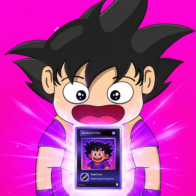 A vibrant anime-style character resembling young Goku with spiky black hair and large excited eyes, holding a glowing card displaying 'Dreamer117Zz' and 'Real Ones - People playing the long game.'