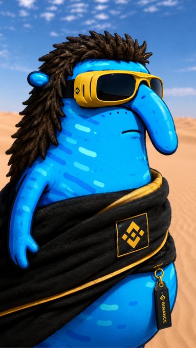 A blue cartoon character with a long nose, spiky black hair, and yellow sunglasses wearing a Binance-branded black garment in a desert landscape.