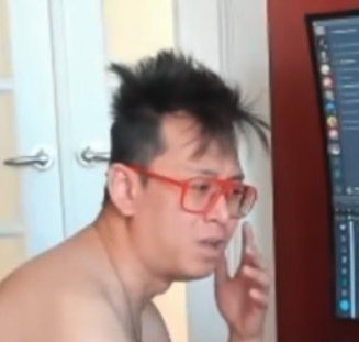 A shirtless man with messy dark hair and red-framed glasses talks on his phone in front of a computer monitor. The image humorously illustrates the post's contrast between "CT influencers" who once made violent threats and now react emotionally to criticism of their trading decisions.