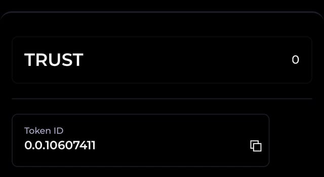 The image displays a digital wallet or token interface showing a balance of "TRUST" with a value of "0" and the Token ID "0.0.10607411." This relates to the post by showing that the user's wallet holds $TRUST tokens, which are the staking rewards earned through DOVU.