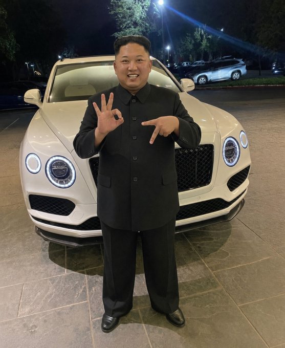 The image shows a person in a suit standing confidently in front of a luxury car, making a hand gesture that resembles a peace sign. This visual metaphorically corresponds to the message in the accompanying post, which speaks to the concept of rounding things up and removing what no longer serves growth, paralleling the person's celebratory pose with the chat emoticon and the idea of 'nuking' as a way to eliminate barriers to success in personal or community development.