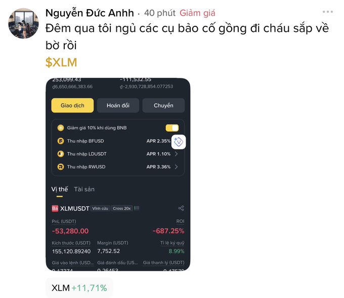 The image shows a screenshot or photo of a computer screen displaying information about a cryptocurrency exchange called XLM. On the screen, there are two price indicators for XLM - one labeled with "XLM" and another "1.7%", showing the current price and the change in value over time. There is also a text bubble below the image that reads "Done... Lost big time, Đức Anh's switched to spiritual stuff now. Down over 53,000 Dương Dây".

The accompanying post on social media references this particular exchange and includes some statistics about it. However, these numbers are shown in a foreign language (either Vietnamese or Chinese) that may be difficult for viewers to understand, as they seem quite complex with various symbols.
