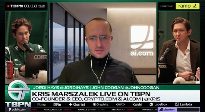 A screenshot from TBPN news program showing Kris Marszalek, Co-Founder & CEO of Crypto.com & AI.com, being interviewed live, with co-anchors Jordi Hays and John Coogan visible