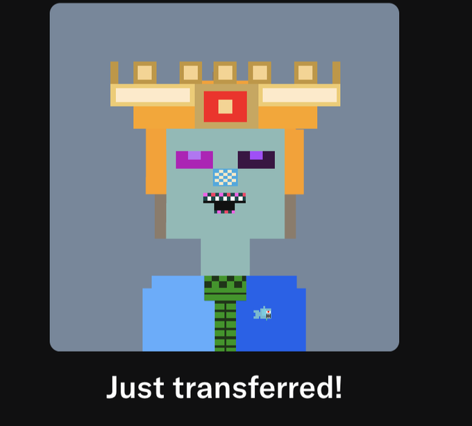 A pixel art character with light blue skin, purple eyes, and a wide toothy grin, wearing a blue shirt and green scarf, topped with an orange and yellow geometric headpiece. The text 'Just transferred!' is written below.