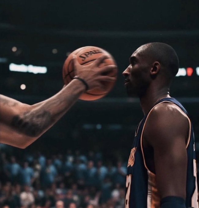 A basketball player in a Knicks jersey stares down an opponent who's casually holding a Spalding ball in his face. The image mirrors the post's mockery of "buy the dip" traders who panic at minor pullbacks—the defender's frozen, intimidated reaction captures exactly the same fragility the post is mocking.