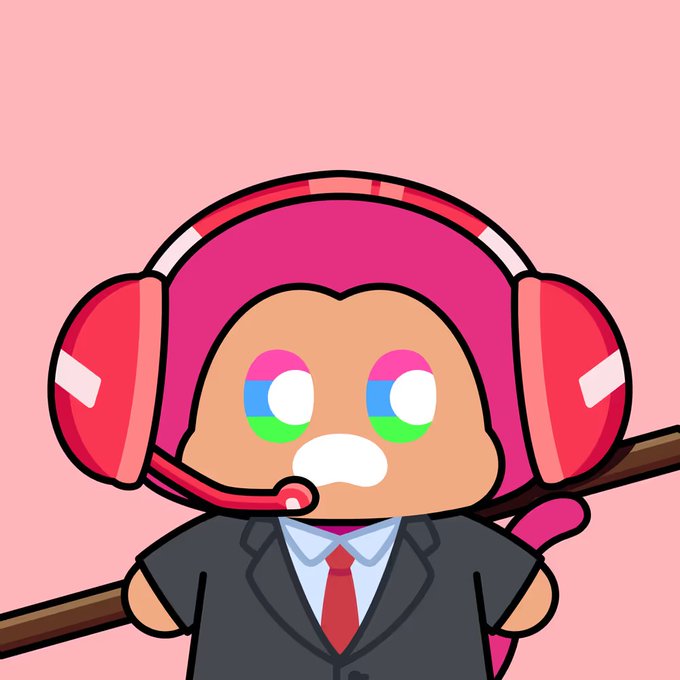 A cartoon character wearing a pink headset with a microphone and a grey business suit with a red tie, featuring pansexual pride flag colored eyes, on a pink background.