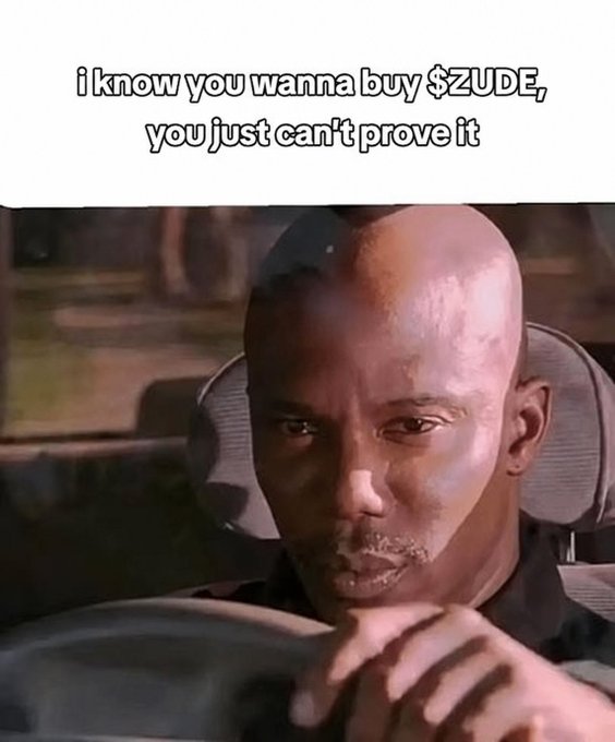 The meme features a serious-looking man in a car with the caption "i know you wanna buy $ZUDE, you just can't prove it," playfully teasing that viewers are secretly interested in the $ZUDE ticker being promoted.