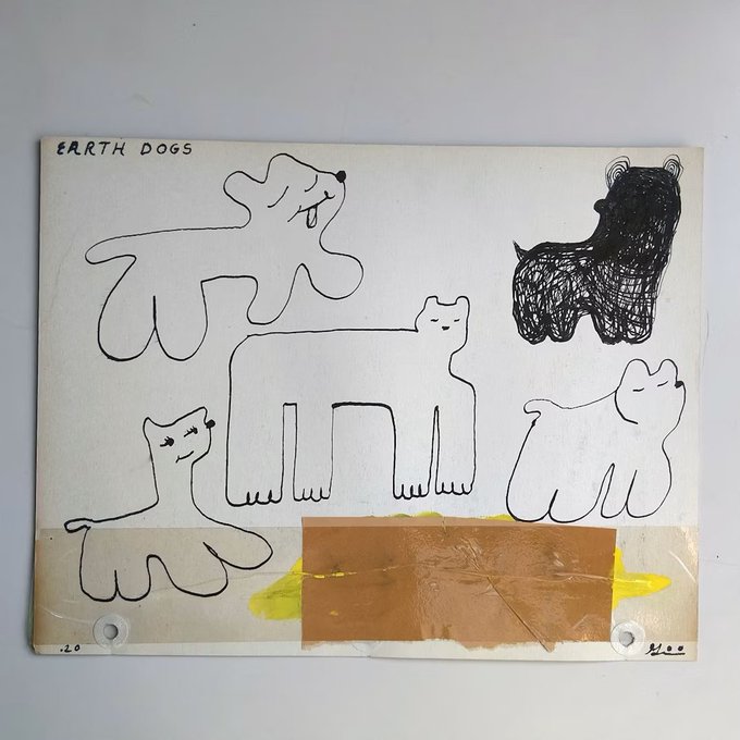A piece of artwork or canvas titled 'EARTH DOGS' featuring simple black line drawings of various dogs and a cat, with some taped brown paper and yellow paint at the bottom.