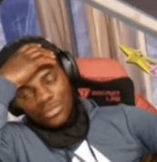 A person wearing headphones sits in a gaming chair with their hand on their head, looking exasperated or tired, with a yellow star graphic in the corner.
