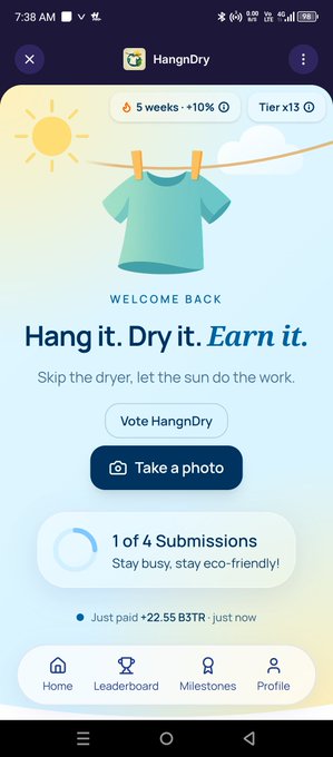 The HangnDry mobile app welcome screen displaying 'Hang it. Dry it. Earn it.' with a t-shirt illustration, a '1 of 4 Submissions' progress indicator, and a recent payment of +22.55 B3TR.