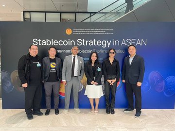 A group of five people posing for a photo in front of a banner that reads 'Stablecoin Strategy in ASEAN', featuring various flags including Indonesia's.
