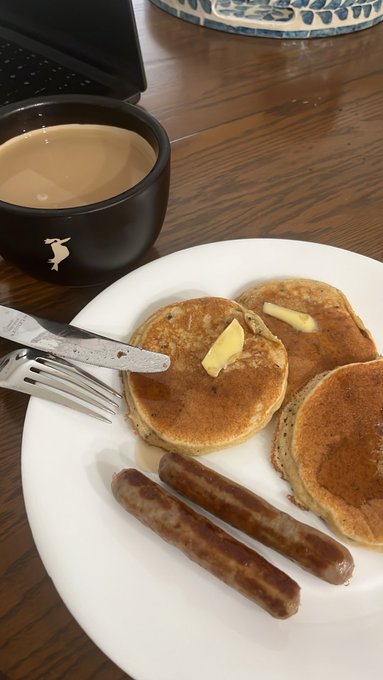 A cup of coffee and pancakes with butter and two sausage links, captured alongside a "Good morning!" post hoping everyone's tokens last longer for the day.