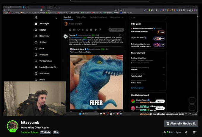 The image shows a streamer named "hitasurek" broadcasting live on X (formerly Twitter), with their screen displaying an X feed where a user "Paulo Arduino" has posted a photo of a blue toy dinosaur with the caption "FEFER." A chat overlay in the bottom right shows viewers asking about the $FEFER token, aligning with the streamer's announcement about playing Among Us and discussing the 2x $FEFER token.