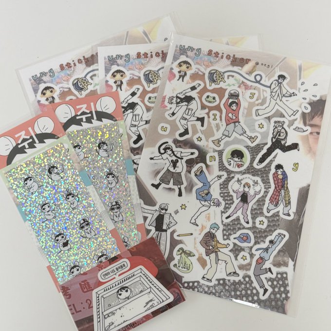 An assortment of sticker sheets featuring cartoon characters, with visible text including 'ung sticker', '진짜' (Korean for 'real'), and 'EL:2'.