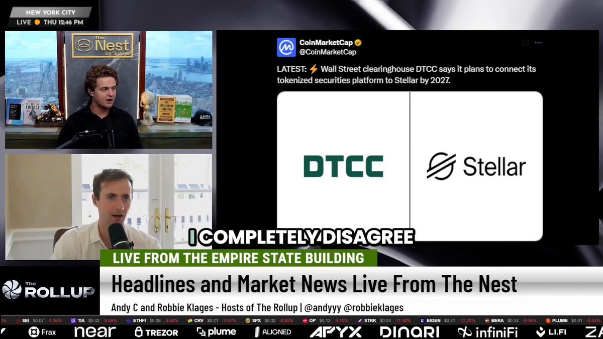 The image shows a TV screen with two men sitting at a table, one man wearing a black shirt and the other wearing a white shirt. They are both talking into microphones while looking at a computer monitor displaying news articles about cryptocurrency markets. The news articles include information about companies like DTCC and Stellar.