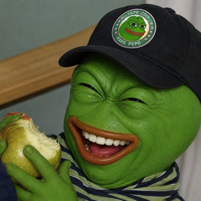 A green Pepe the Frog mask wearing a black cap labeled 'PEPE COIN RARE PEPE' while eating a pear.