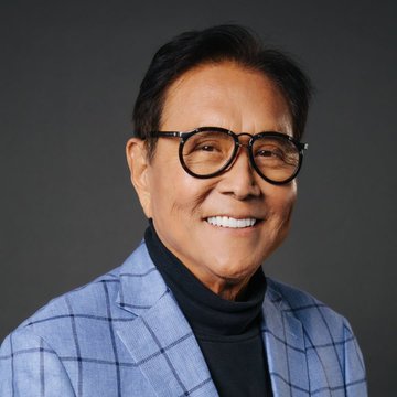 Robert Kiyosaki smiles in a studio portrait, wearing glasses, a black turtleneck, and a light blue checkered blazer—presented as the face behind the bold prediction that Ethereum could surge to $95,000 by mid-2027.