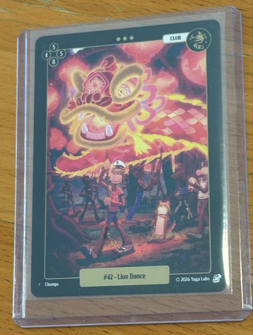 A sleeved trading card reads “#42 - Lion Dance,” with “CLUB,” “Champs,” and “©2026 Yuga Labs” also visible.