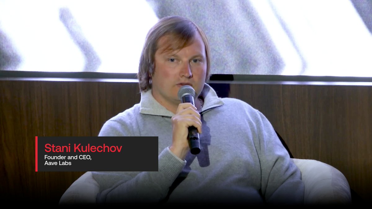 Stani Kulechov, Founder and CEO of Aave Labs, speaking into a microphone while seated on a panel.