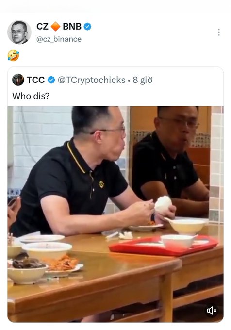 A screenshot of a tweet from CZ (Changpeng Zhao) of Binance responding to TC Cryptochicks' "Who dis?" with a laughing emoji, featuring a video still of two men sitting at a restaurant table with bowls of food, captioned to highlight that despite CZ's engagement, the $TCC token has failed to move.